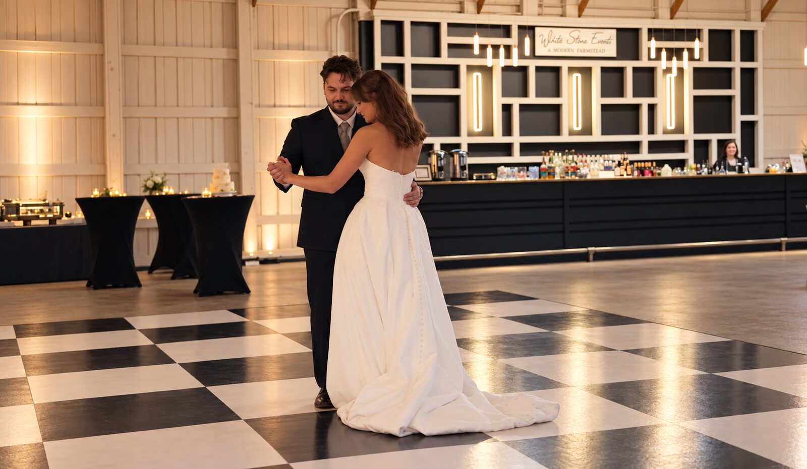 Chase and Emma's first dance on the black-and-white checkered dance floor at White Stone Events